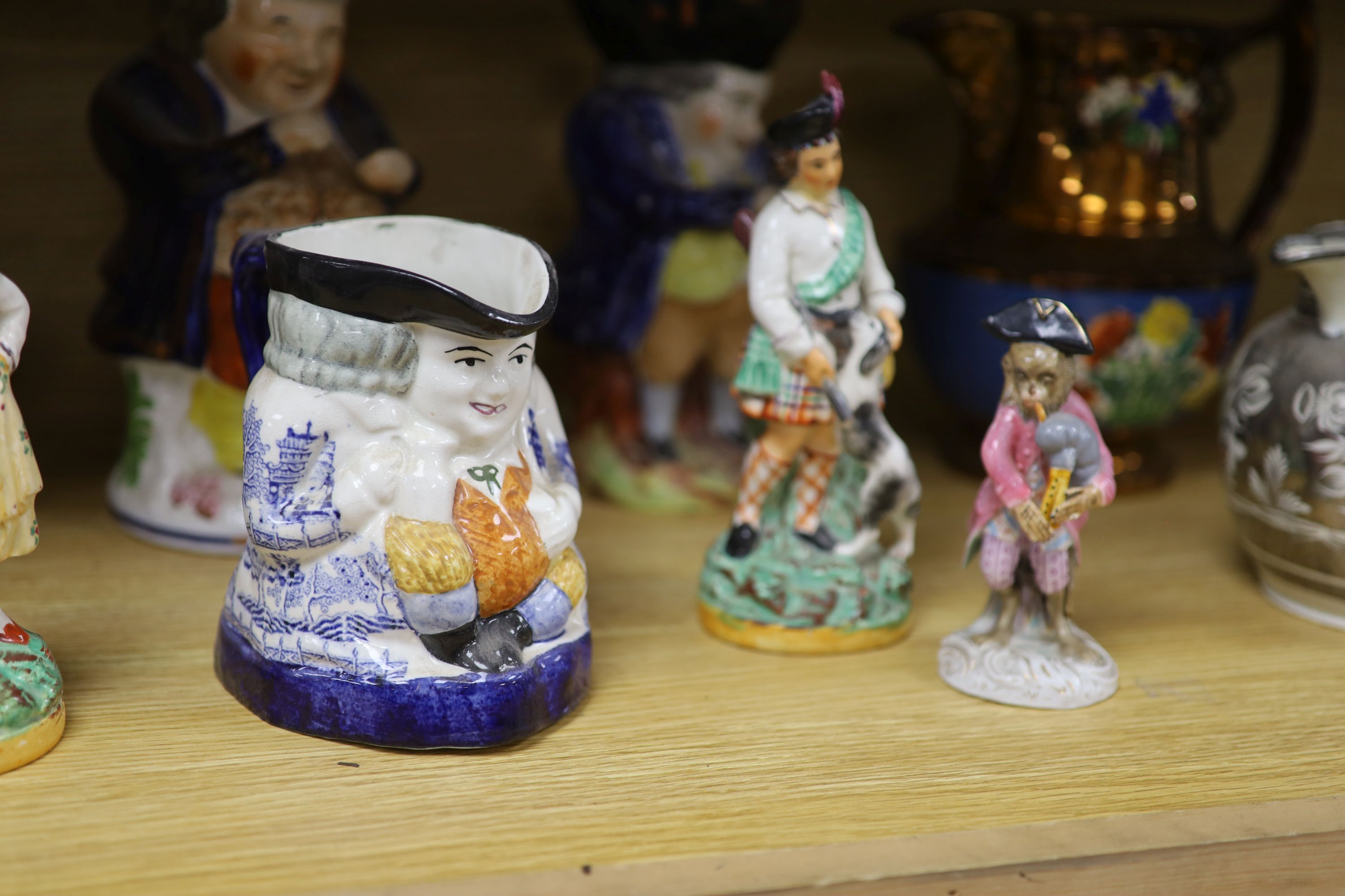 A quantity of Staffordshire pottery, including four Toby jugs, four figures, a copper lustre jug and a silver resist jug (10)